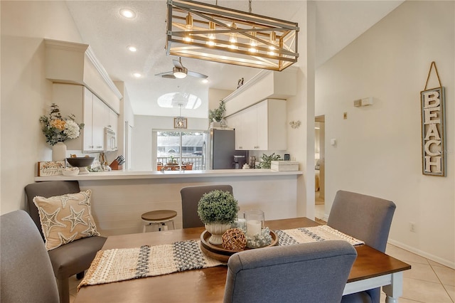 dining area with lofted ceiling, light tile patterned floors, recessed lighting, and baseboards