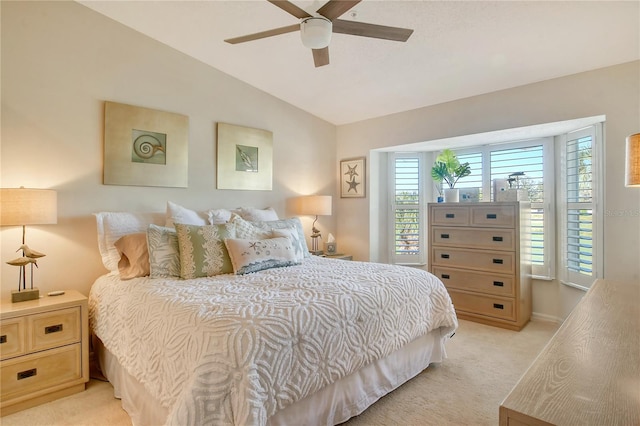 bedroom with light carpet, a ceiling fan, and vaulted ceiling