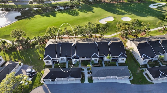 aerial view with a water view and view of golf course