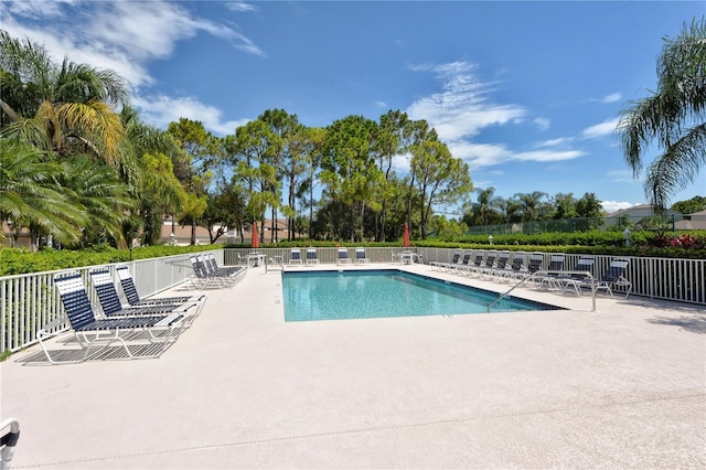 community pool featuring a patio and fence