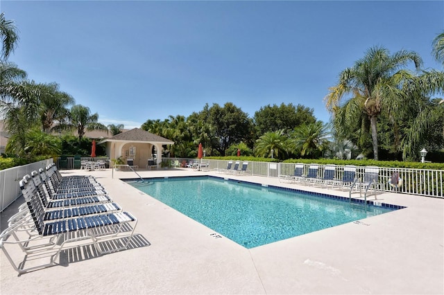 community pool featuring a patio and fence