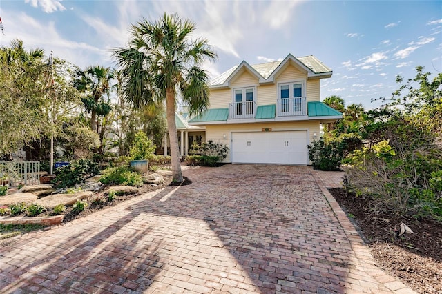 view of front facade with an attached garage and decorative driveway