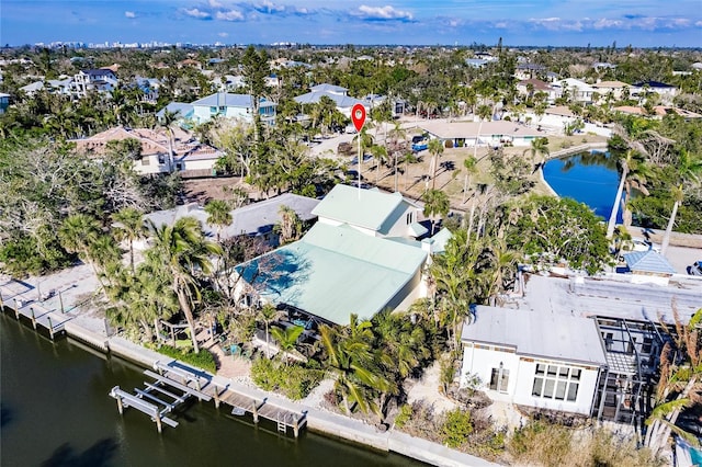 drone / aerial view featuring a residential view and a water view