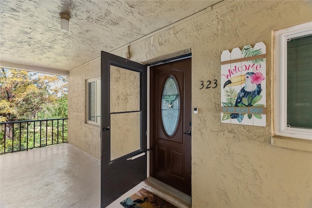 doorway to property with stucco siding