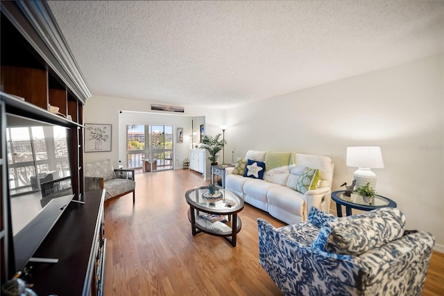 living area featuring a textured ceiling and wood finished floors