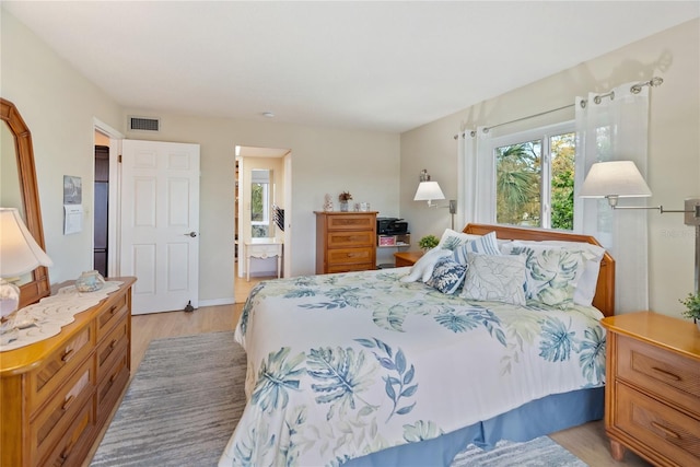 bedroom with visible vents and light wood finished floors