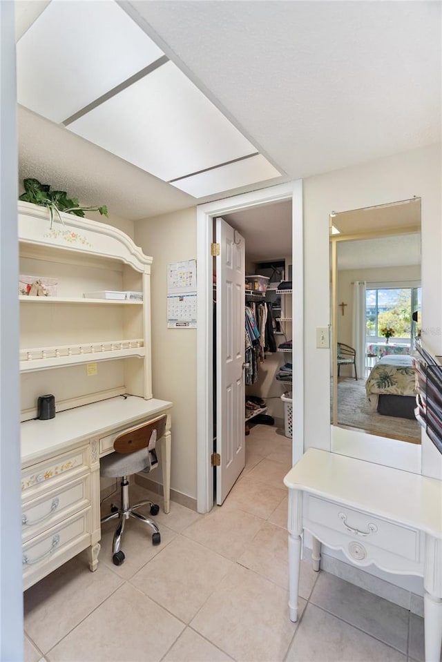 office featuring light tile patterned floors and baseboards