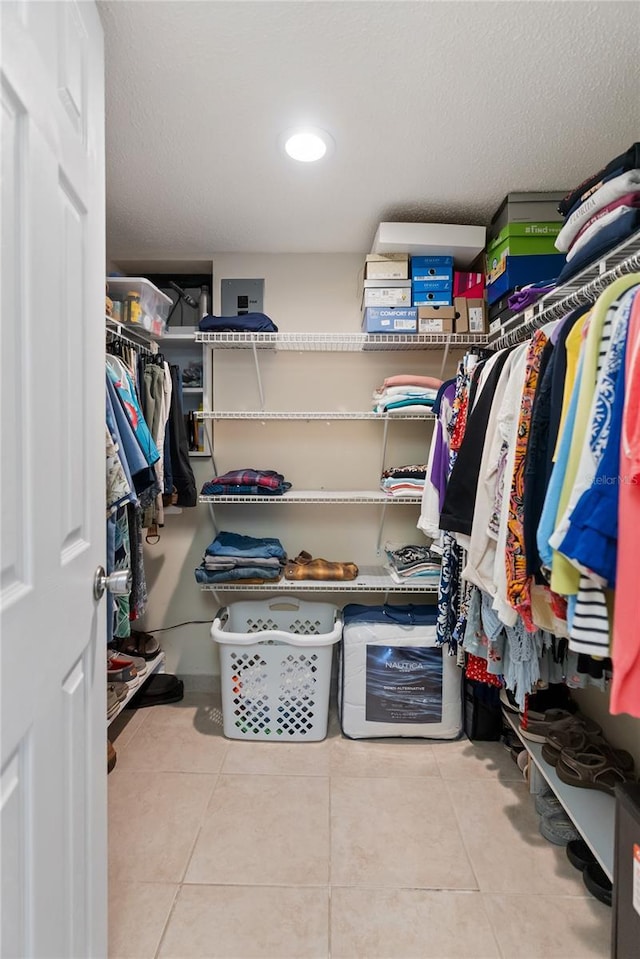 walk in closet with tile patterned floors