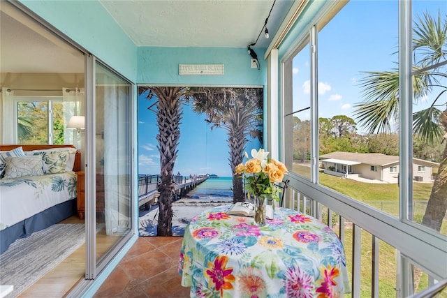 sunroom / solarium featuring a water view