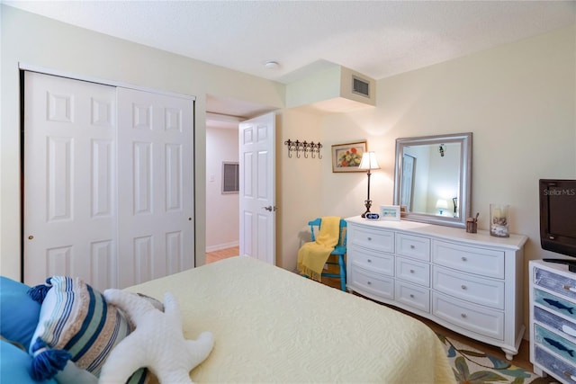 bedroom with a closet and visible vents