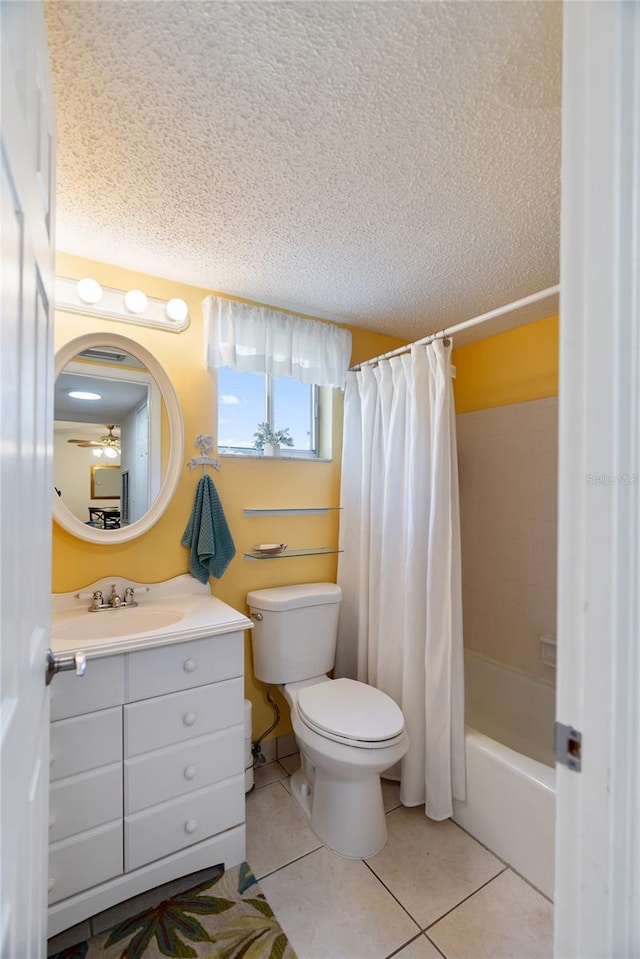 full bathroom featuring shower / bath combo, toilet, tile patterned flooring, a textured ceiling, and vanity