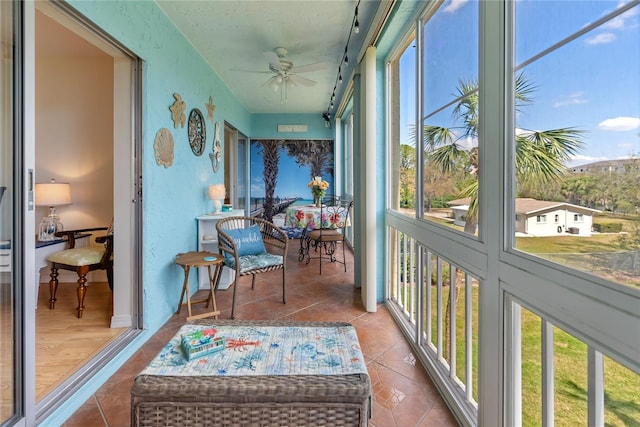 sunroom / solarium featuring ceiling fan and a wealth of natural light