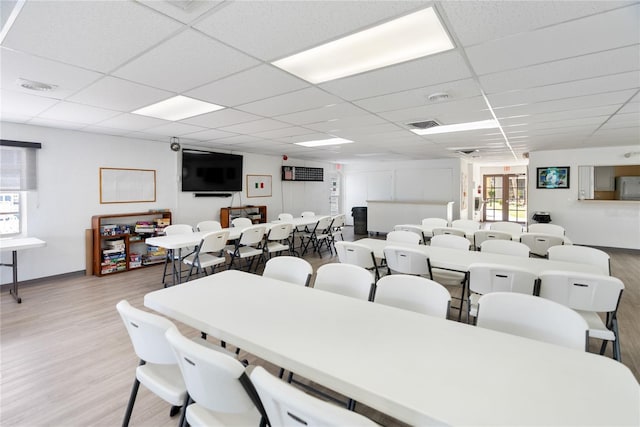 dining space with visible vents, a paneled ceiling, and light wood-style floors