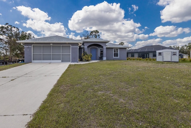 view of front of home with a garage, driveway, a front yard, and stucco siding