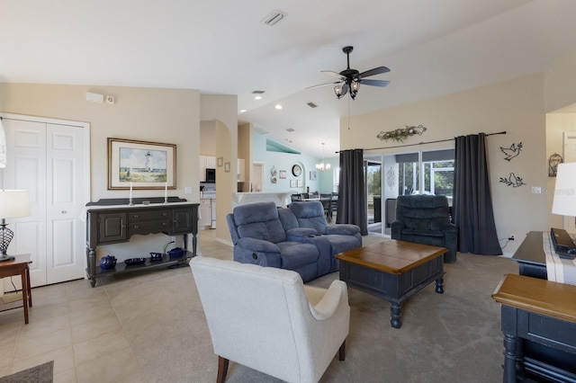 living area with ceiling fan with notable chandelier, high vaulted ceiling, light tile patterned flooring, and visible vents