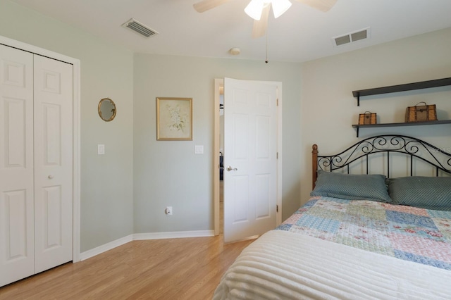 bedroom featuring light wood-type flooring, baseboards, visible vents, and a ceiling fan