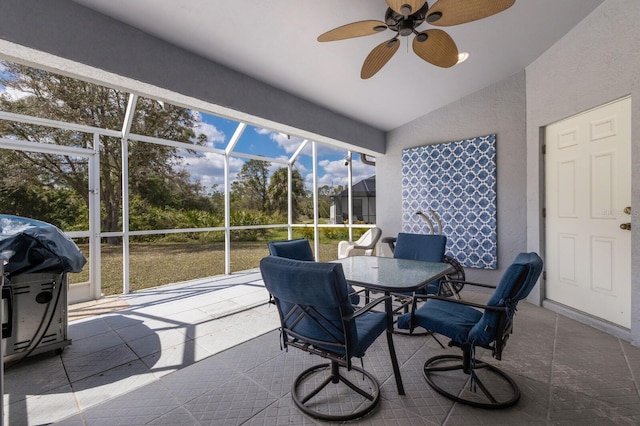 sunroom featuring vaulted ceiling and a ceiling fan