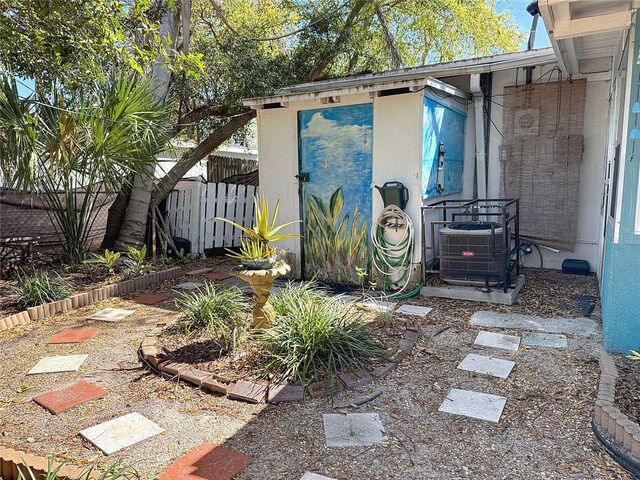 exterior space with fence and central AC unit