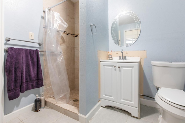 bathroom with tile patterned flooring, a shower stall, toilet, and vanity