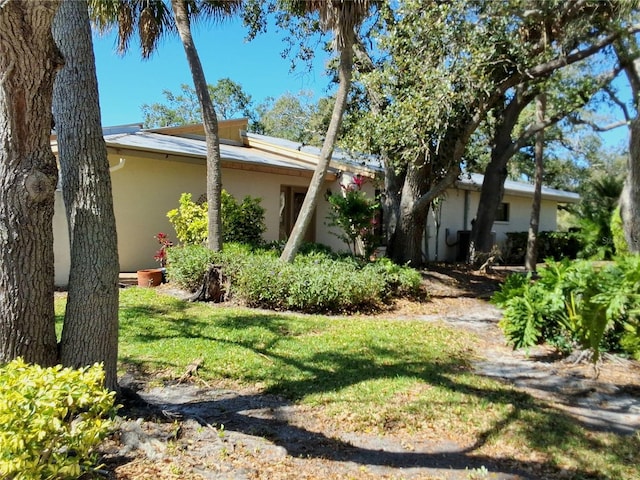 exterior space with a yard and stucco siding