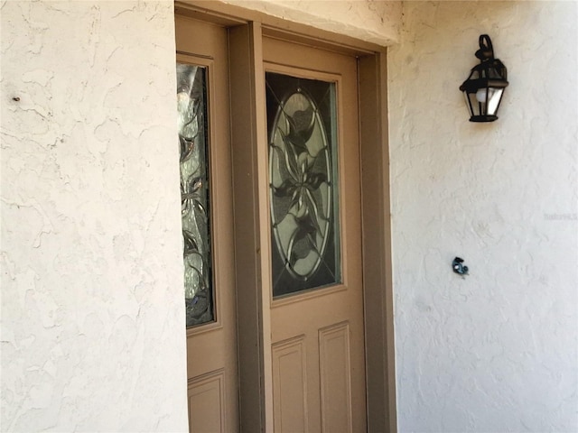 entrance to property with stucco siding