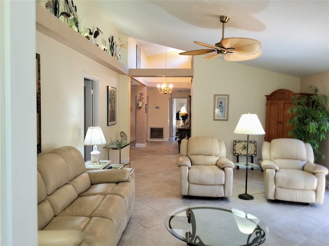 living area featuring ceiling fan with notable chandelier, vaulted ceiling, and light tile patterned floors