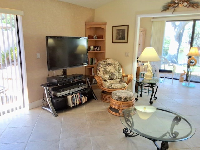 living area featuring tile patterned flooring and baseboards