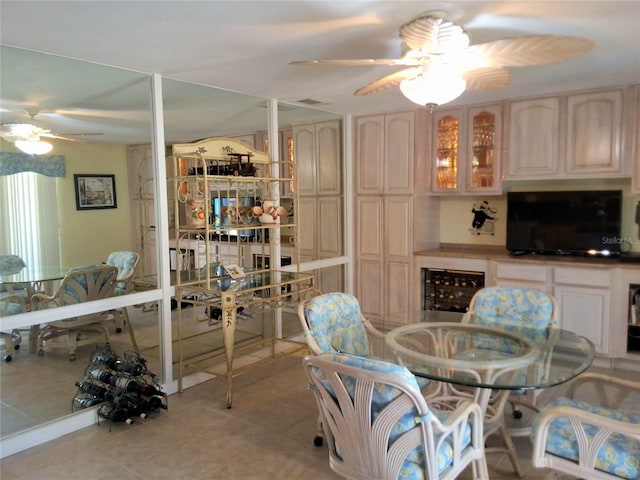 interior space with light tile patterned floors, ceiling fan, and wine cooler