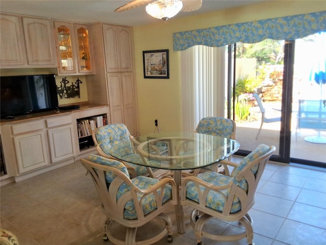 dining room with a ceiling fan and light tile patterned flooring