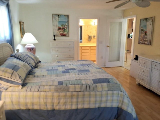 bedroom with ceiling fan, light wood-style flooring, and ensuite bath