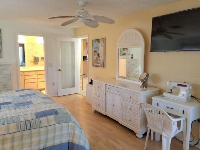 bedroom featuring ensuite bathroom and light wood-type flooring