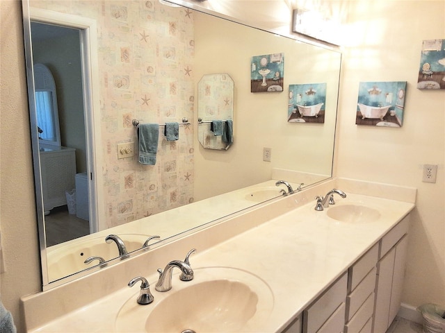 full bathroom with a sink and double vanity