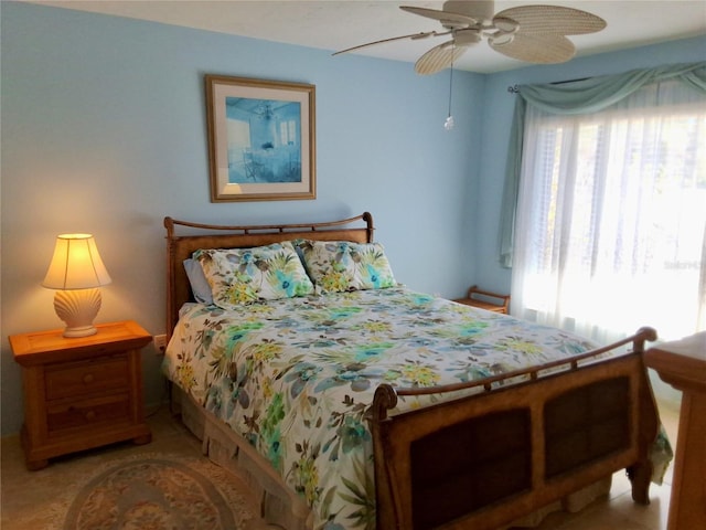 bedroom with ceiling fan and multiple windows