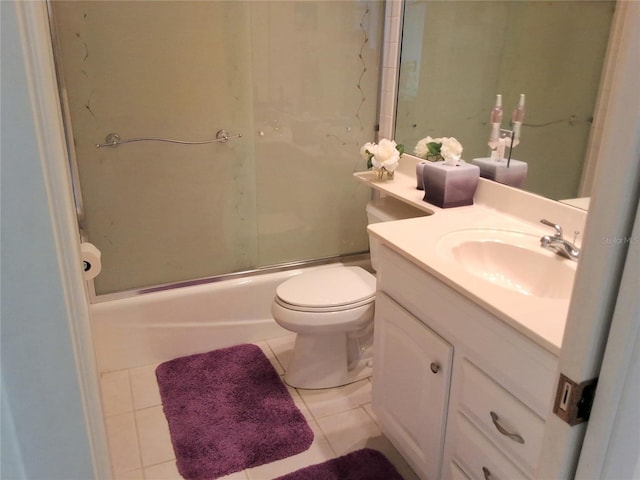 bathroom with toilet, bath / shower combo with glass door, vanity, and tile patterned floors