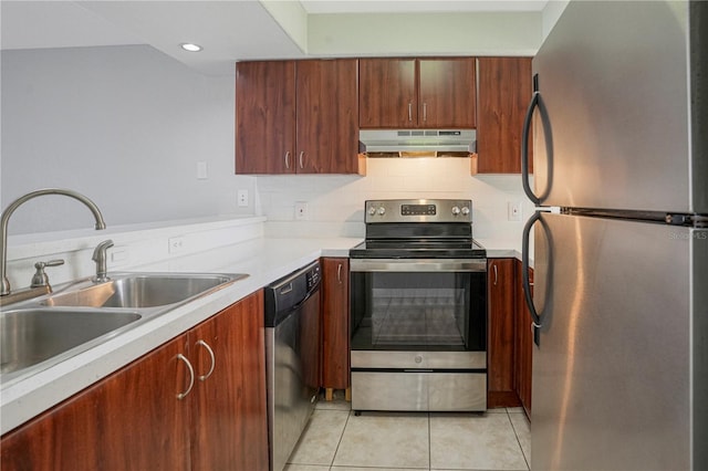 kitchen featuring light tile patterned floors, stainless steel appliances, light countertops, a sink, and under cabinet range hood