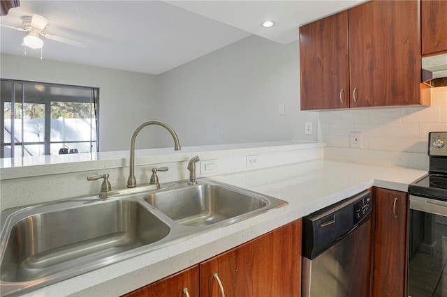 kitchen featuring tasteful backsplash, stainless steel appliances, light countertops, under cabinet range hood, and a sink