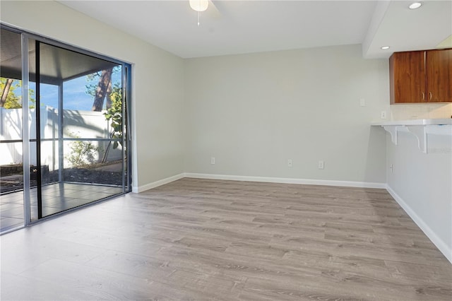 interior space featuring light wood finished floors, baseboards, and recessed lighting