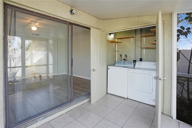 laundry area with laundry area, light tile patterned floors, visible vents, ceiling fan, and washing machine and clothes dryer