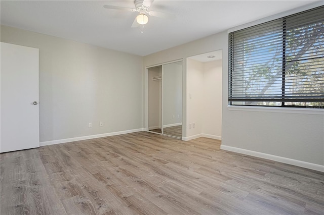 unfurnished bedroom with ceiling fan, a closet, wood finished floors, and baseboards