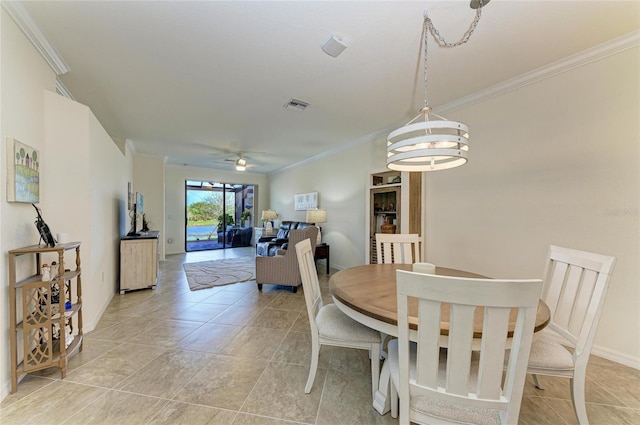 dining space with ceiling fan with notable chandelier, ornamental molding, and visible vents