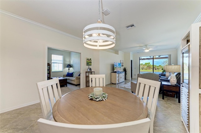 dining space with baseboards, light tile patterned floors, visible vents, and crown molding