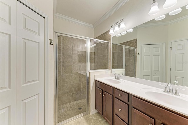 full bathroom with ornamental molding, tile patterned flooring, a sink, and a shower stall