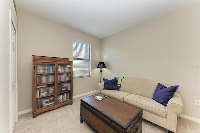 living room featuring light carpet and baseboards