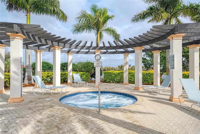 view of swimming pool featuring a hot tub, a pergola, and a patio