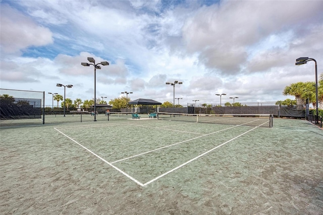 view of tennis court with fence