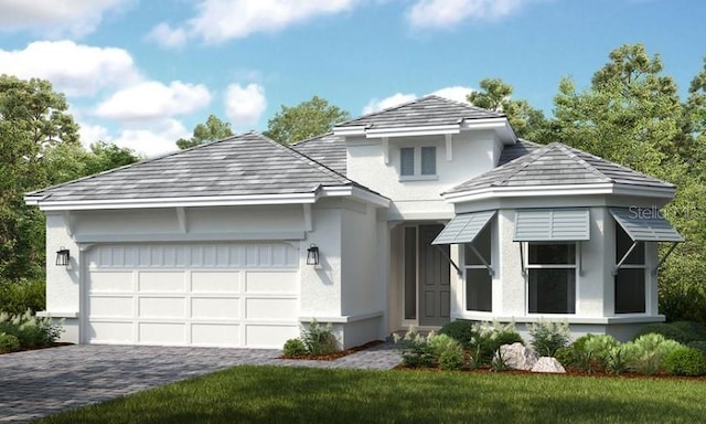 view of front of home featuring decorative driveway, an attached garage, and stucco siding