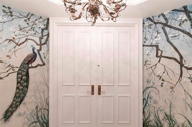 interior space with a notable chandelier and a textured ceiling