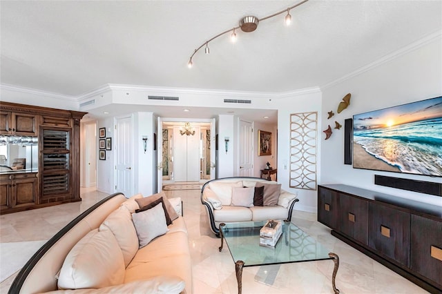 living area featuring visible vents, crown molding, and baseboards