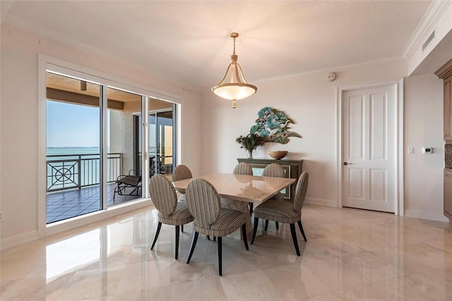 dining room with marble finish floor, crown molding, and baseboards