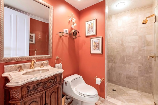 full bath featuring toilet, tiled shower, and vanity